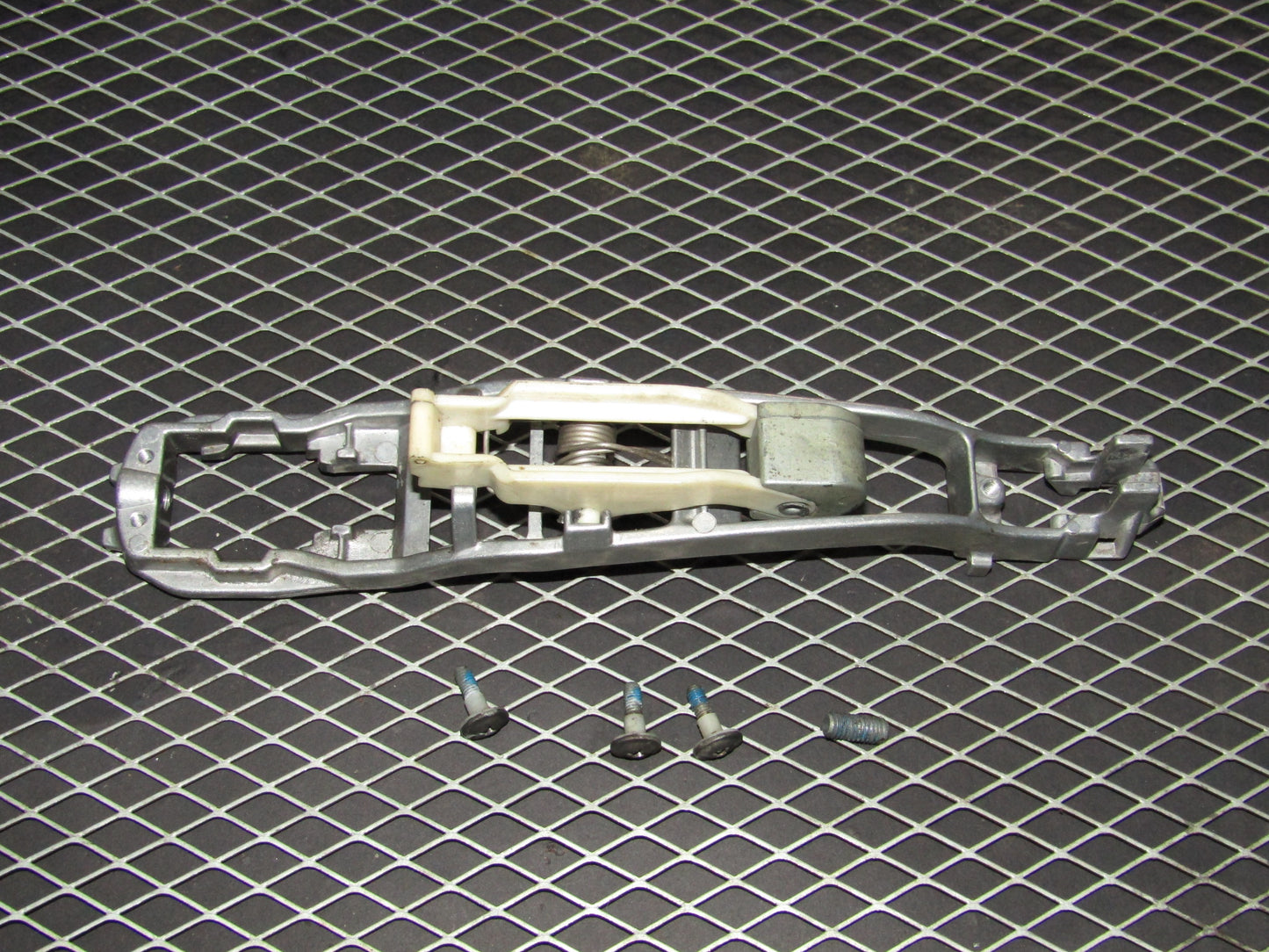 86-93 Mercedes Benz 300E OEM Rear Exterior Door Handle Mounting Bracket - Left